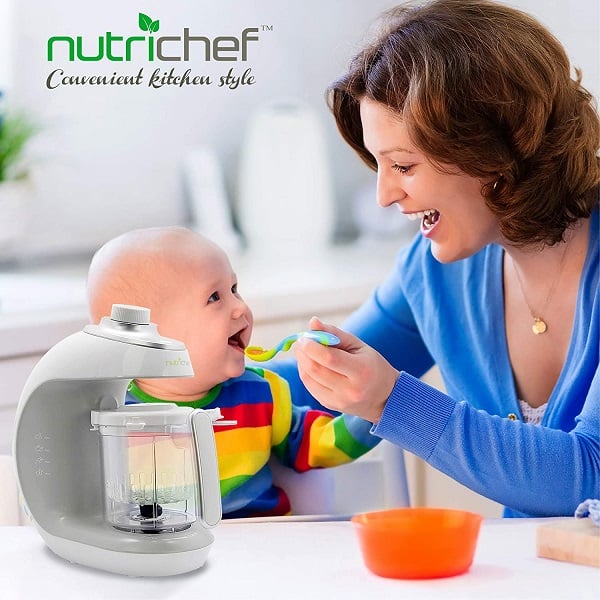 A mom feeding her infant with baby food using one of the Best Baby Food Maker and Blender in 2021