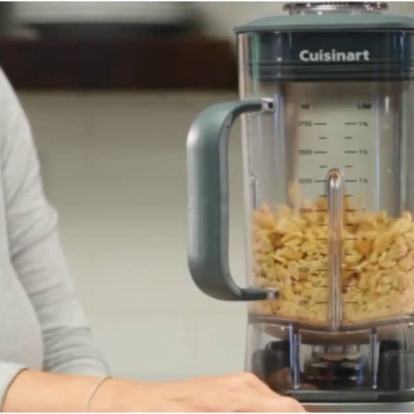 A woman using one of the Best Cuisinart Blender to blend a creamy peanut butter