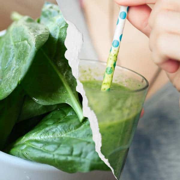 A girl sipping a frozen spinach smoothie